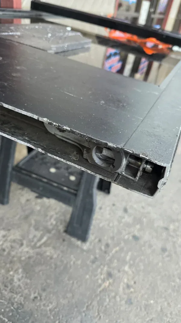 Pivot assembly visible inside the bottom rail of the removed glass door