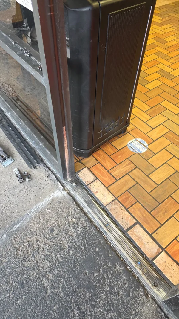 Commercial entrance threshold beside the interior tile