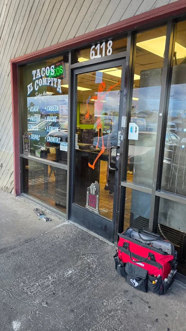 Black-framed commercial glass entrance viewed from outside