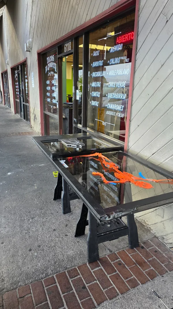 Commercial glass door supported on work stands outside the storefront