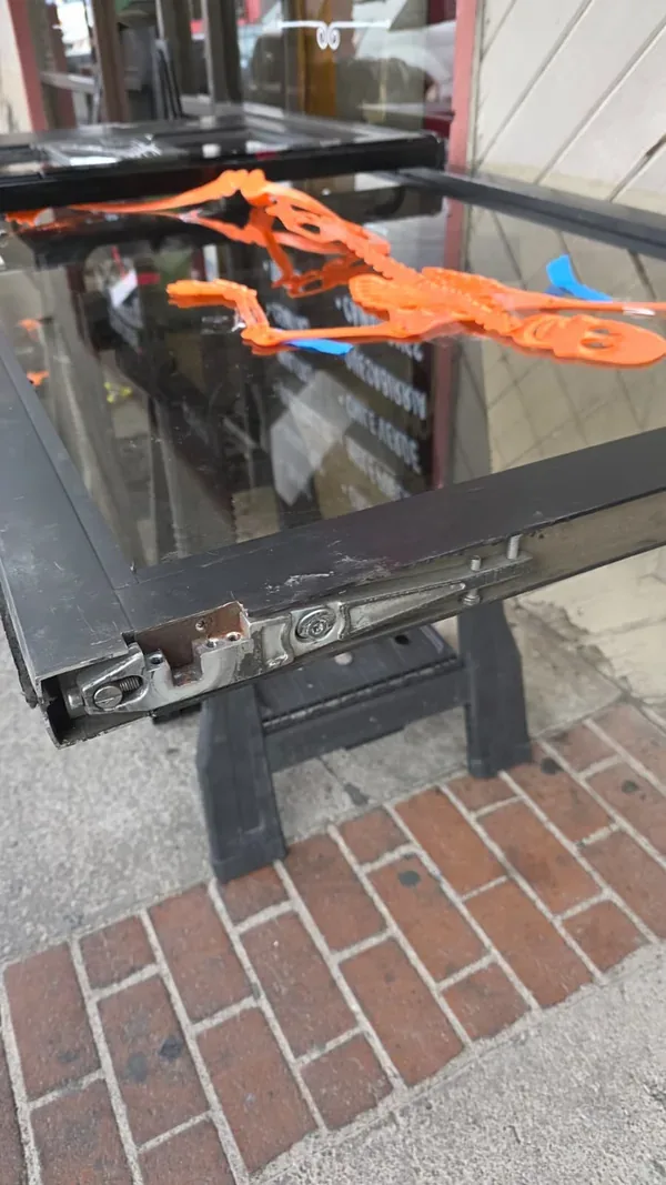 Close-up of the supported commercial glass panel and rail