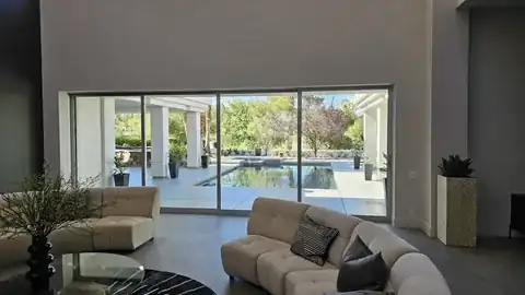 Multi-panel sliding glass doors facing a pool